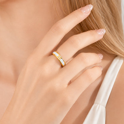 Gold spinning ring from Anxiety Rings Australia with a central gemstone on a hand against a neutral background